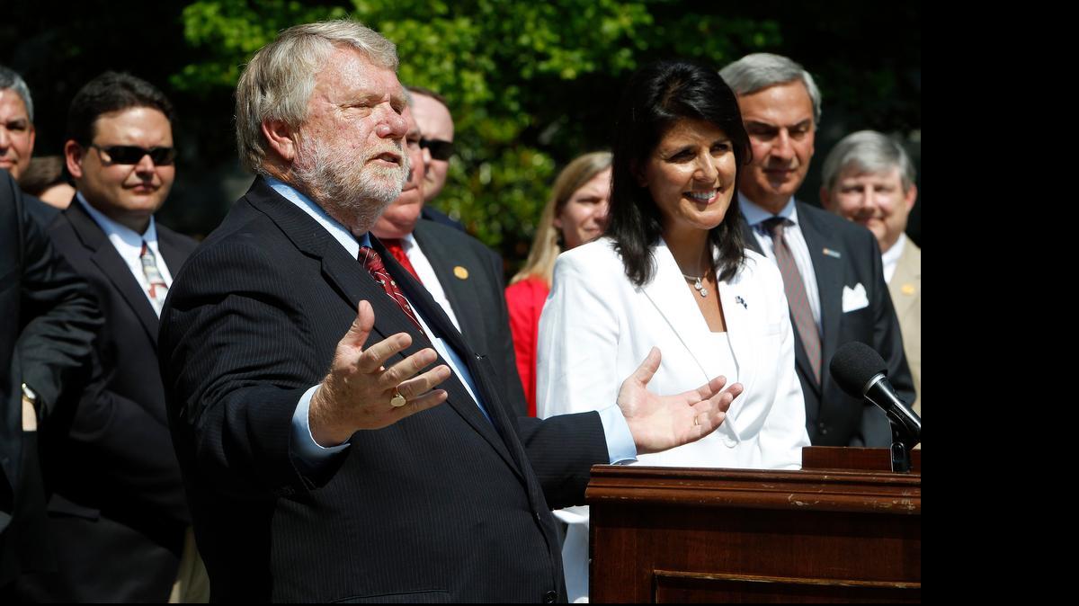 
Commerce Secretary Bobby Hitt is joined by Gov. Nikki Haley and state officials outside the Governor's Mansion on May 11 as they make it official by announcing Volvo will build a $500 million factory in Berkeley County to produce 100,000 cars a year.
