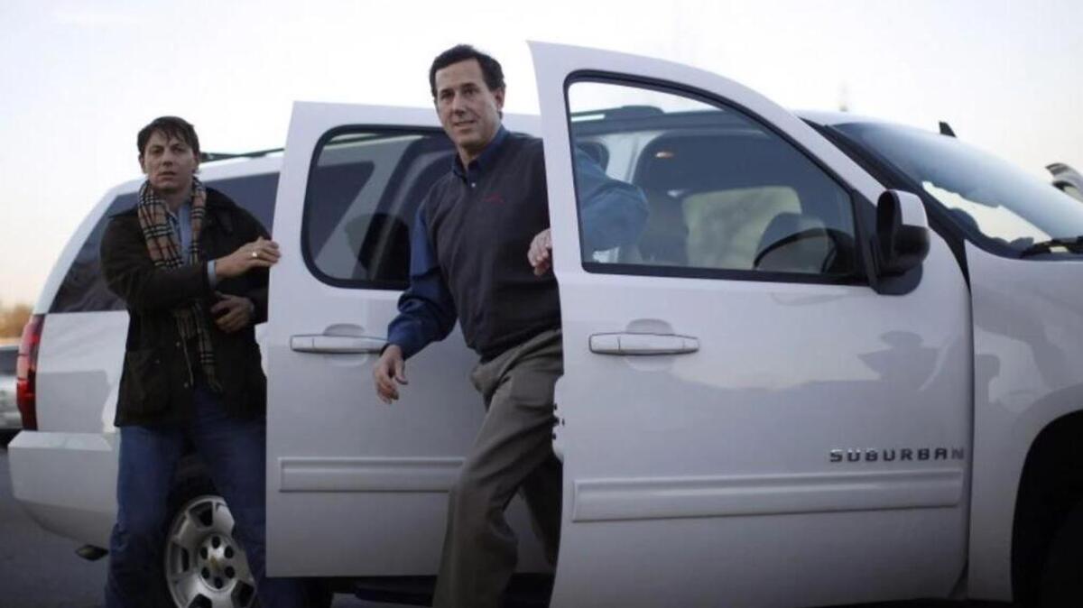 Hogan Gidley, left, steps out of a car with former Pennsylvania senator Rick Santorum at a presidential campaign event in Spartanburg, S.C., in January 2012, during Santorum's bid.
