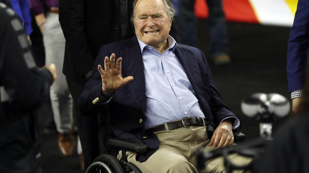 FILE - In this April 2, 2016, file photo, former President George H. W. Bush waves as he arrives at NRG Stadium before the NCAA Final Four tournament college basketball semifinal game between Villanova and Oklahoma in Houston.