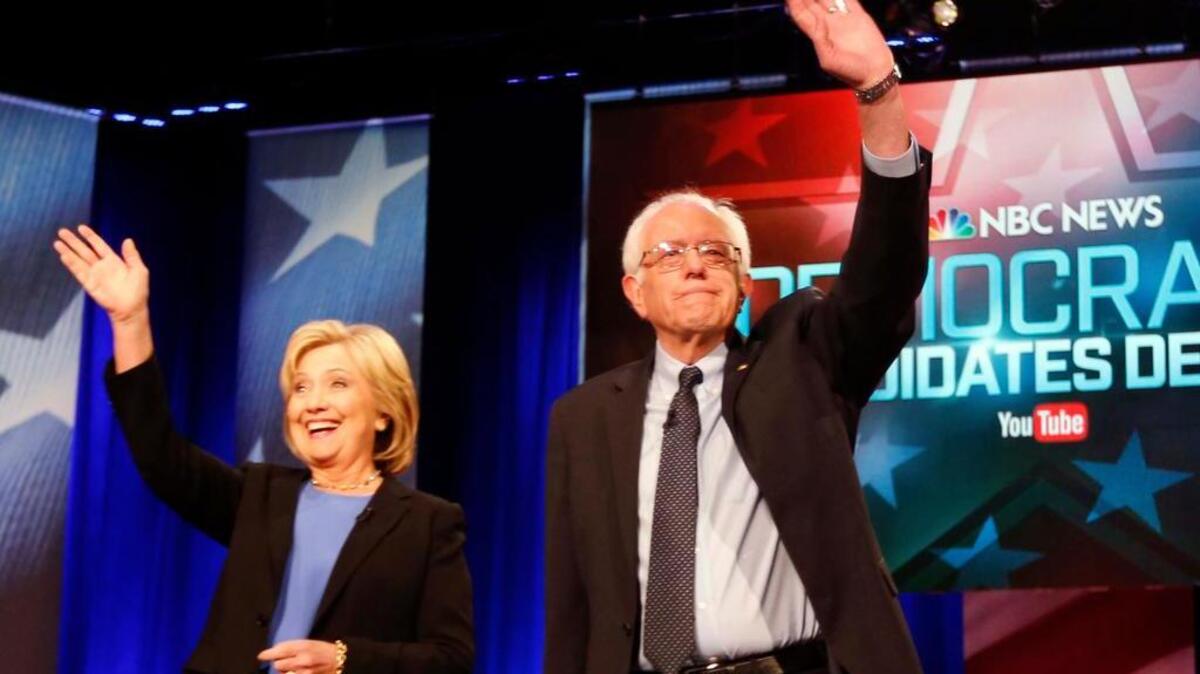 FILE - In this Jan. 17, 2016 photo, Democratic presidential candidates, Hillary Clinton and Sen. Bernie Sanders, I-Vt, stand together before the start of the NBC, YouTube Democratic presidential debate at the Gaillard Center in Charleston, S.C. The Democratic presidential campaigns of Hillary Clinton and Bernie Sanders reached an agreement in principle on Saturday to hold another presidential debate next week in New Hampshire and three more later this spring.
