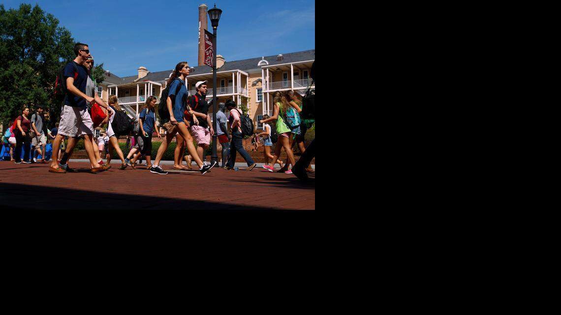 
University of South Carolina students make their way past the Russell House on campus.
