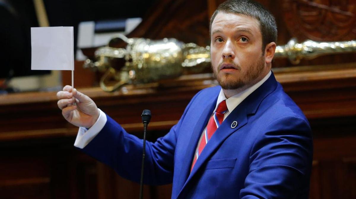 Rep. Christopher Corley, R- Aiken, shows his frustration by waving a white flag of surrender during debate over a Senate bill calling for the Confederate flag to be removed from the Capitol grounds in July.