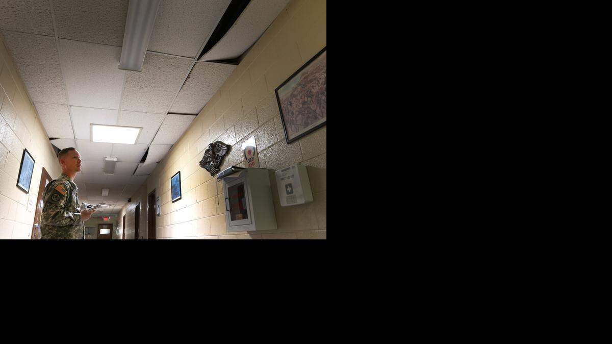 
Maj. Marty Hanks observes damaged ceiling tiles that are falling down at the National Guard Armory in Greenwood. 
