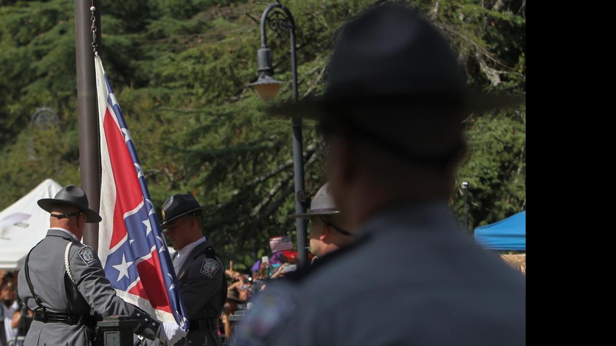 
An honor guard from the State Highway Patrol removes the Confederate flag from the State House grounds for the last time on Friday.
