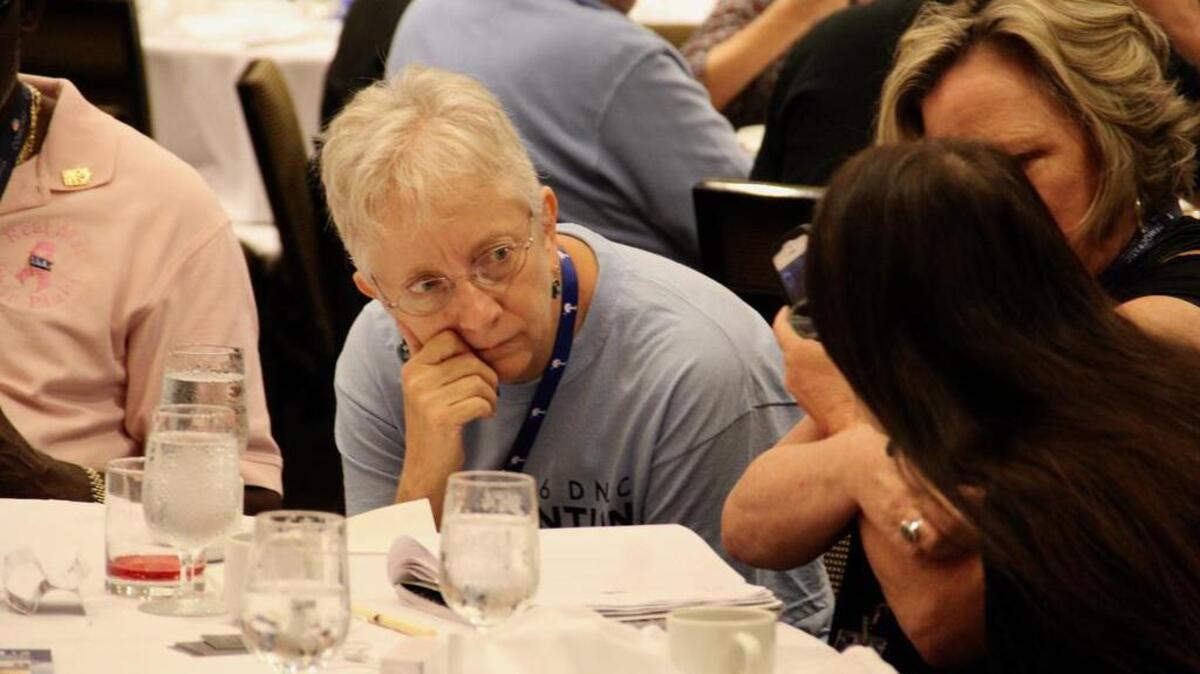 Deborah Adams, a delegate from South Carolina's seventh congressional district who cast a ballot Tuesday for Bernie Sanders, confers with fellow Sanders delegates during breakfast at the Democratic National Convention in Philadelphia.