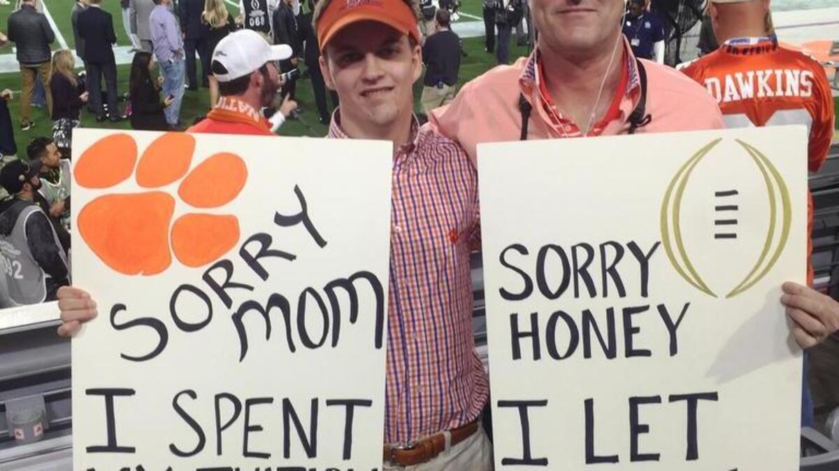 Scott Pyle (left) holds signs that went viral with his son, Dylan, at the NCAA National Championship football game in January in Arizona. Pyle is running for the S.C. Senate for a seat in Horry County.