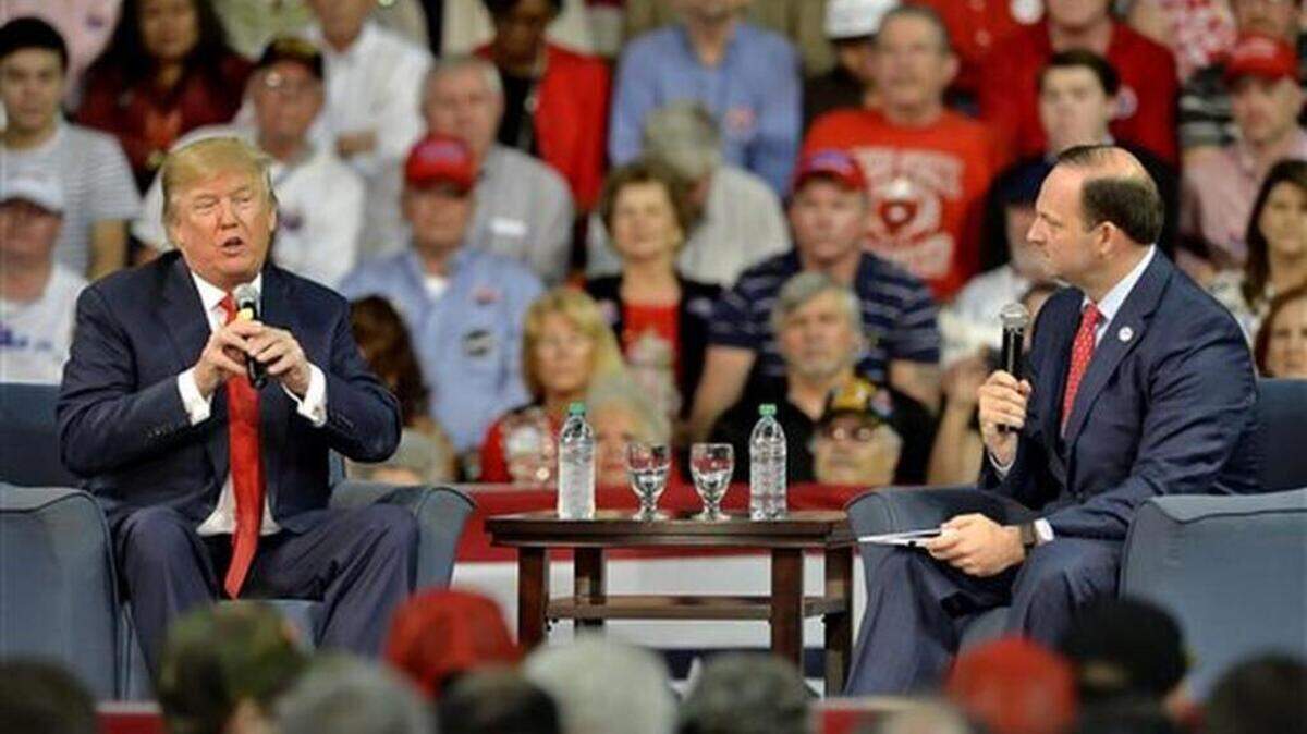Republican presidential candidate Donald Trump answers questions from South Carolina Attorney General Alan Wilson, right, at a town hall meeting in the Convocation Center on the University of South Carolina Aiken campus Saturday, Dec. 12, 2015, in Aiken, S.C.
