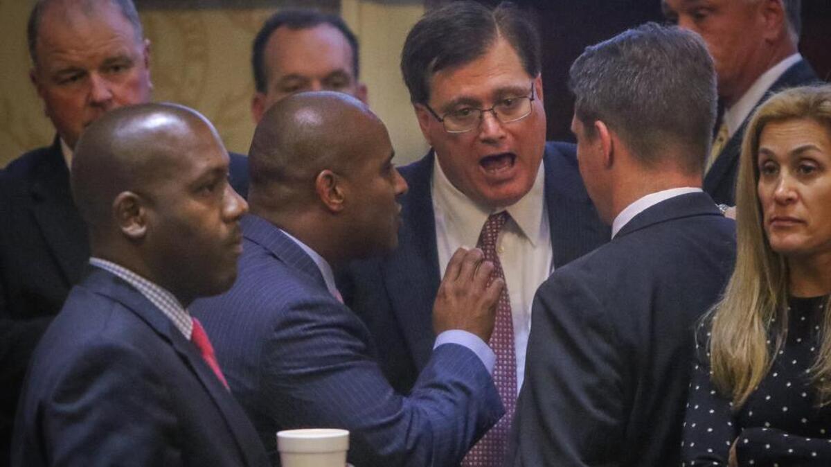 S.C. House Speaker Jay Lucas (middle) talks with House Minority Leader Todd Rutherford (left) and Rep. Jim Smith about proposals to remove the Confederate flag fro. the State House in July.