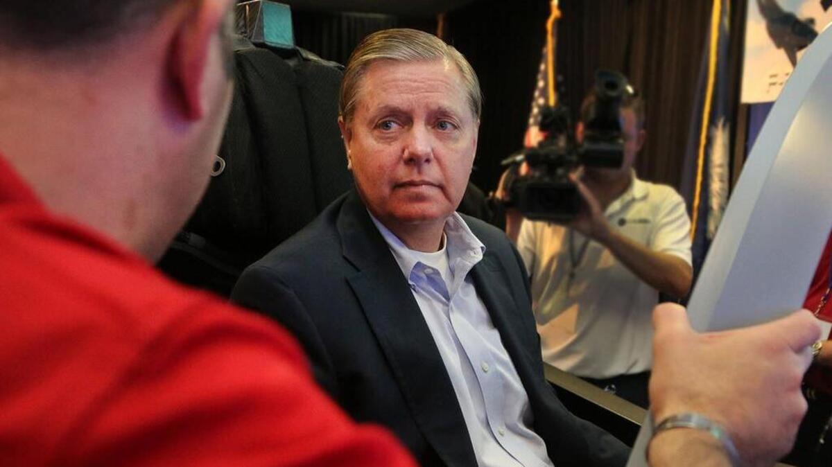 Congressman Graham listens to instruction before trying the Lockheed Martin F-35 simulator at the SC State Museum.