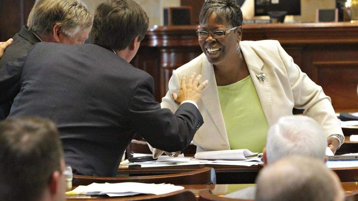 Rep. Gilda Cobb-Hunter shares a laugh with Rep. Nathan Ballentine between voting in 2012.