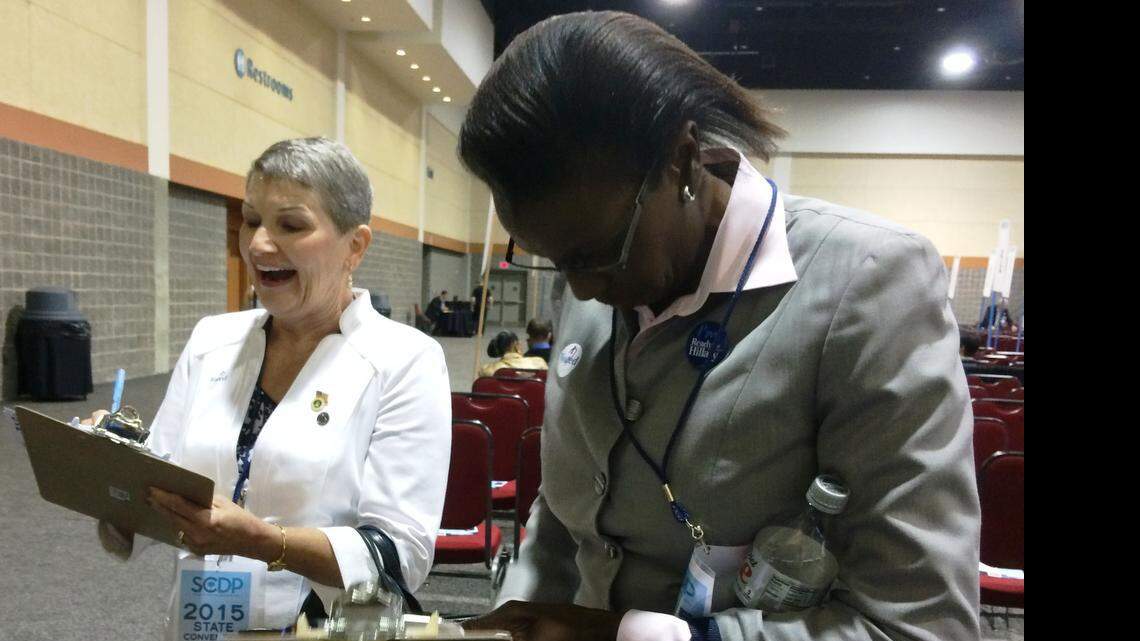 
Irish Eickhoff, 64, and Dora Graham, 53, sign up as supporters of the Hillary Clinton campaign at the S.C. Democratic Party Convention on Saturday. Both said they plan to vote for Clinton.
