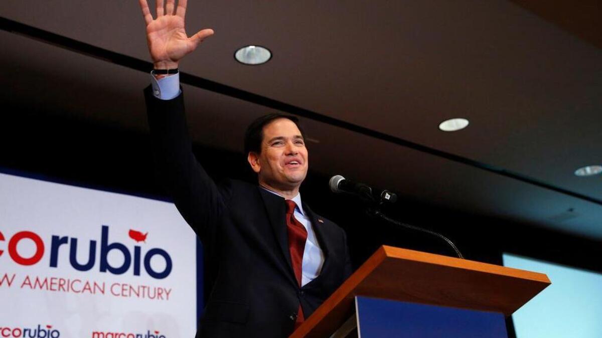 Republican presidential candidate Sen. Marco Rubio, R-Fla., waves to supporters at a caucus night rally on Monday in Des Moines, Iowa.