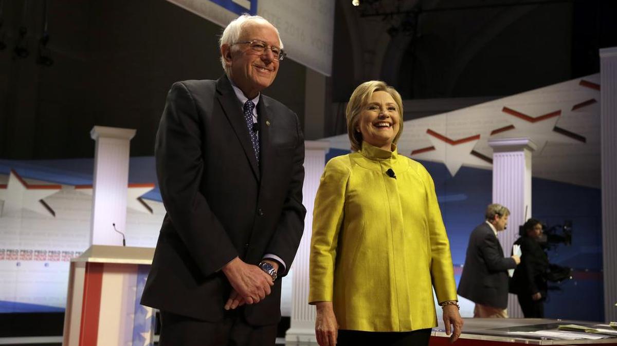 Democratic presidential candidates Sen. Bernie Sanders, I-Vt, left, and Hillary Clinton take the stage before a Democratic presidential primary debate at the University of Wisconsin-Milwaukee on Thursday.