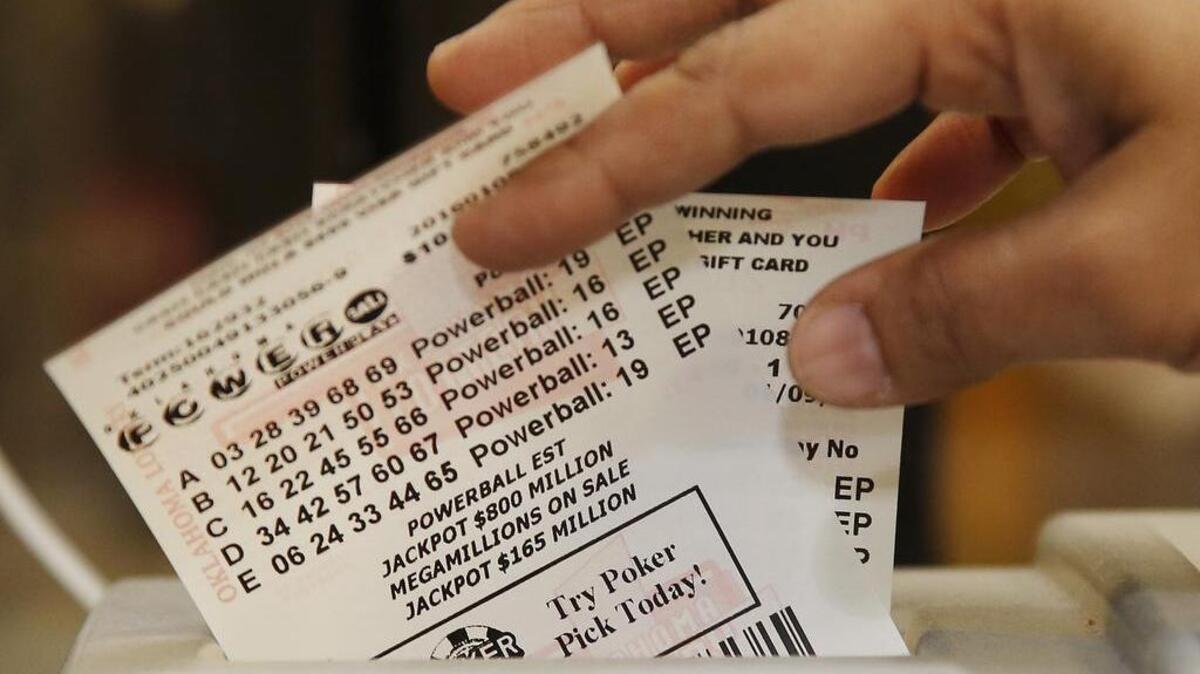Powerball lottery tickets are pulled from a printer at an Oklahoma City store on Friday as the jackpot reached $800 million.