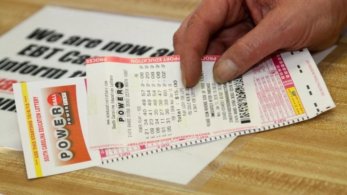 This file photo shows someone buying a Poweball ticket, and a Midlands woman won $2 million playing Powerball, the South Carolina Education Lottery said.