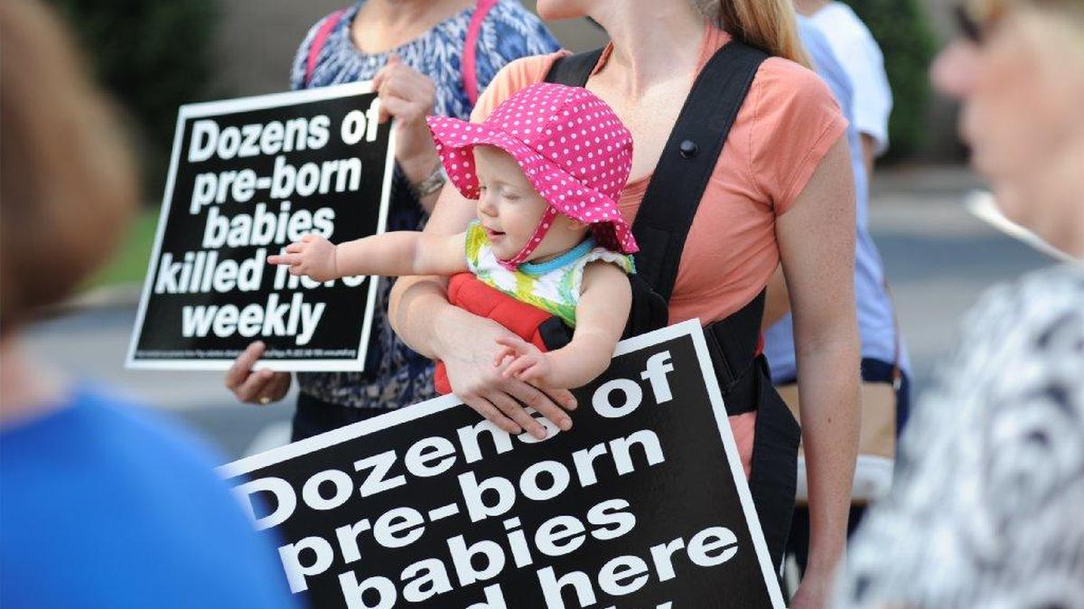 
Lisa Read of Lexington and her thirteen-month-old daughter Hadley Read joined more than a hundred protesters gathered outside Planned Parenthood in Columbia.
