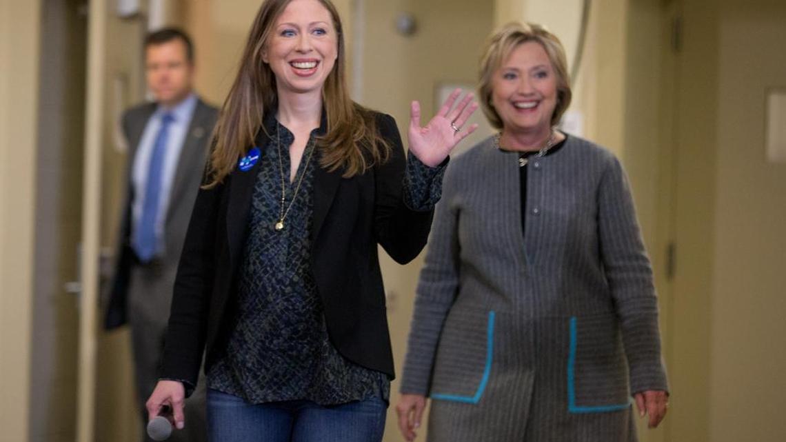 Democratic presidential candidate Hillary Clinton, accompanied by her daughter Chelsea Clinton, arrives for a rally at Abraham Lincoln High School in Council Bluffs, Iowa, on Sunday.
