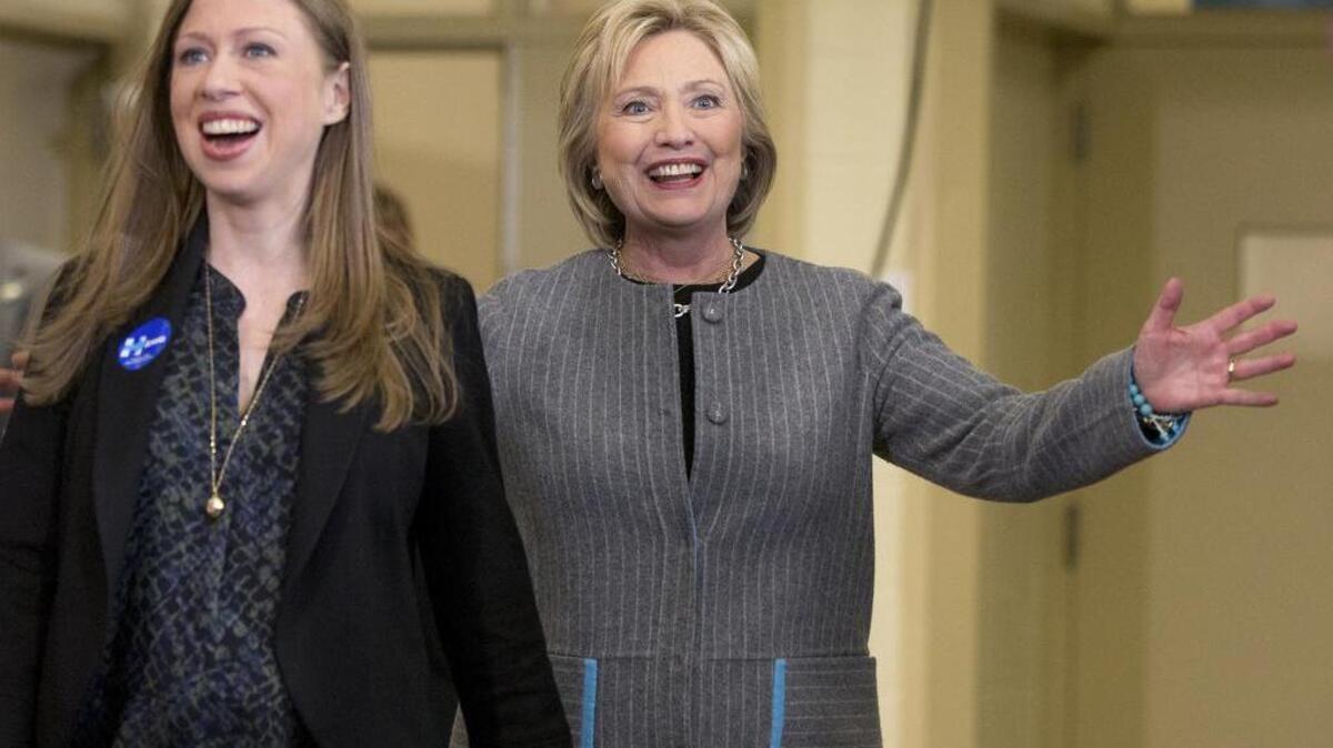 Democratic presidential candidate Hillary Clinton, accompanied by her daughter Chelsea Clinton, reacts to applause as she arrives for a rally at Abraham Lincoln High School in Council Bluffs, Iowa, Sunday, Jan. 31, 2016.