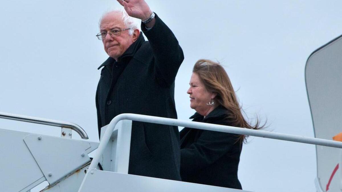 Democratic presidential candidate Sen. Bernie Sanders, I-Vt., with his wife Jane Sanders, waves as they arrive in Chicago on Thursday.