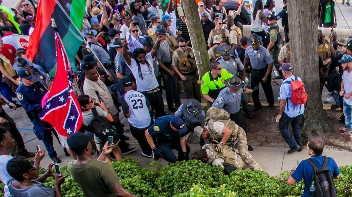 Law enforcement arrest a protestor following a rally at the State House in July that drew supporters of the Ku Klux Klan and Black Panther Party.