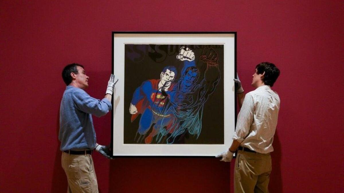 
Michael Dwyer, preparator and exhibit designer, and Daniel Richardson, assistant preparator, hang portraits for the "From Marilyn to Mao, Andy Warhol's Famous Faces" exhibit.
State Sen. John Courson, R-Richland, said exhibits like the Warhol one at the Columbia Museum of Art draw in tourists to the region. 
