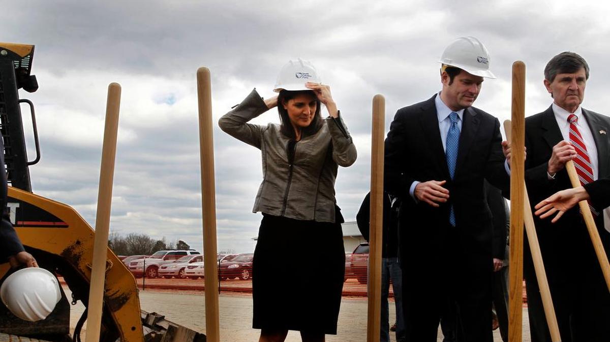 Gov. Nikki Haley, middle, adjusts her hard hat as she prepares to take part in a South Carolina groundbreaking event.