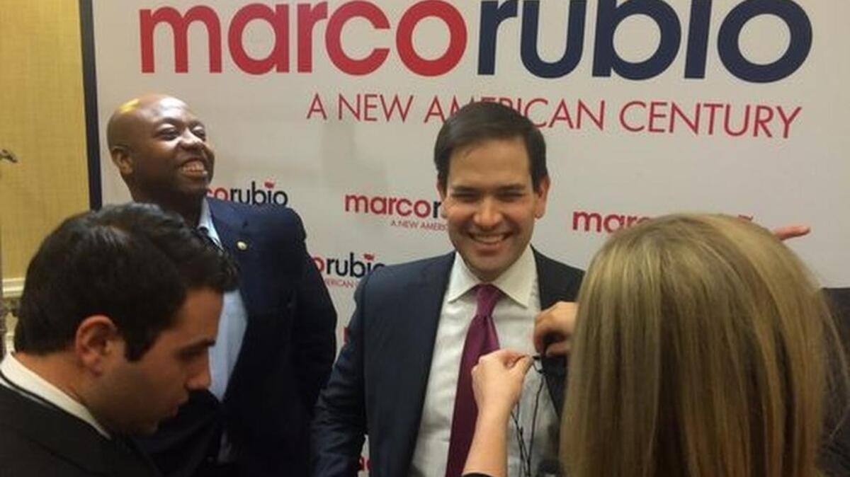 Florida Sen. Marco Rubio gets ready to talk with reporters at the Spartanburg Marriott Wednesday with South Carolina Sen. Tim Scott by his side.