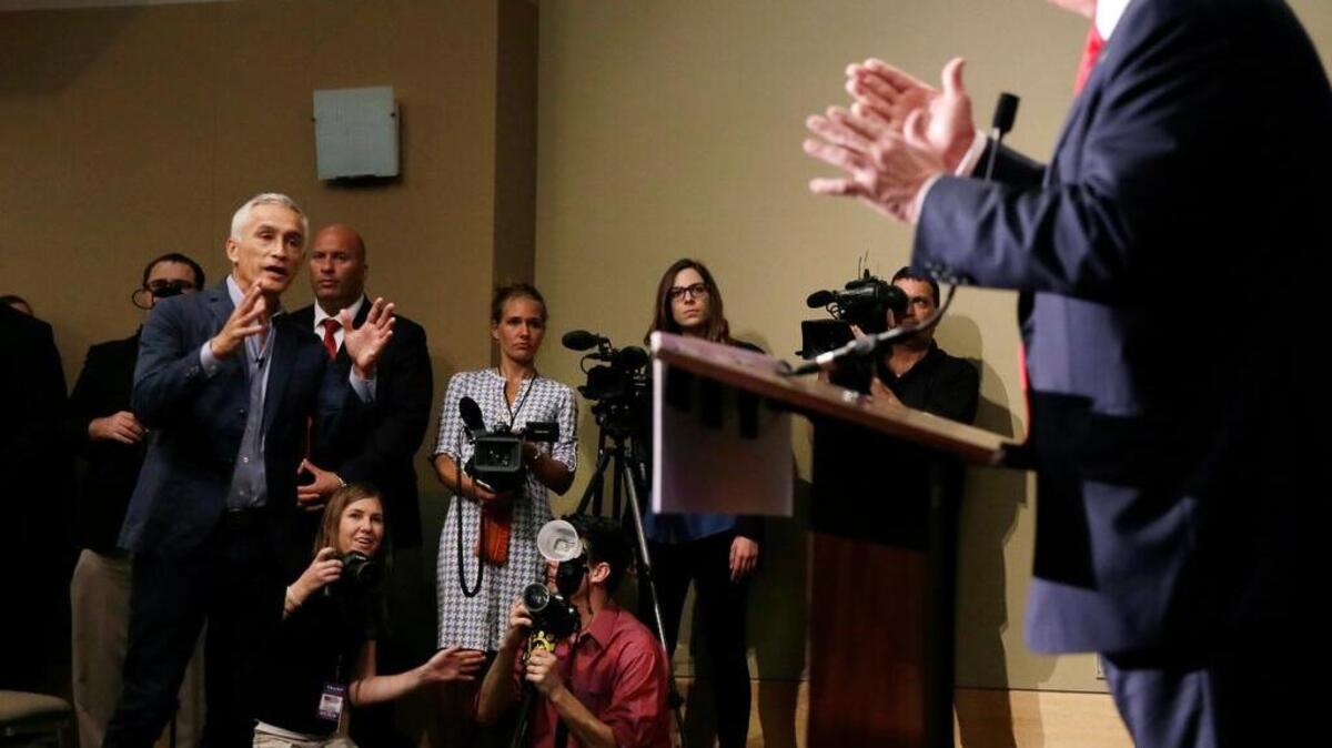 
FILE - In this Aug. 25, 2015 file photo, Miami-based Univision anchor Jorge Ramos, left, asks Republican presidential candidate Donald Trump a question about his immigration proposal during a news conference in Dubuque, Iowa. 
