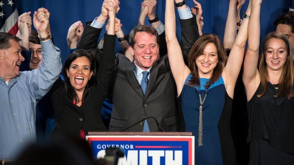 South Carolina Democratic gubernatorial candidate James Smith celebrates a primary victory with lieutenant governor  candidate Mandy Powers Norrell, left, and wife Kirkland Smith.