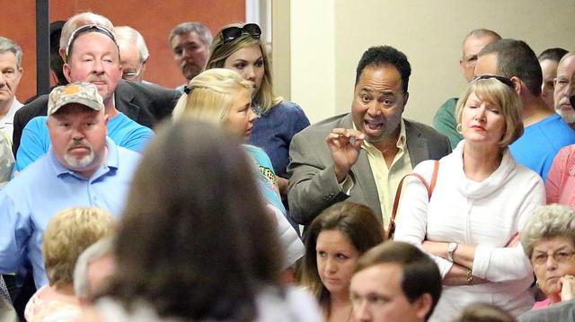 The Rev. Belton Platt (right) of Rock Ministries Church International in Conway talks to MelanieMoore at an Horry County Schools meeting relating to transgender students bathroom use on Monday, May 2, 2016. As the board was in executive session the group began singing and praying until Moore stood to ask why all students shouldn't have the same rights. Her questions and responses to their questions were occasionally drowned out by singing and shouting. When the board reconvened, a resolution to follow the Title IX ruling but support a a Virginia school district challenging the ruling.