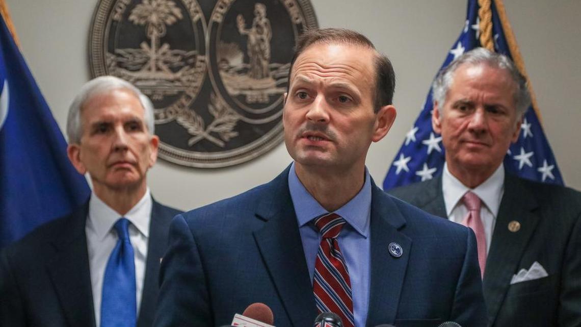 SC Attorney General Alan Wilson at a press conference standing in front of, from left, Charlie Condon and Gov. Henry McMaster.