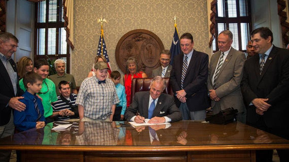 Gov. Henry McMaster signs a bill Wednesday that waives hunting and fishing license fees for terminally ill children.