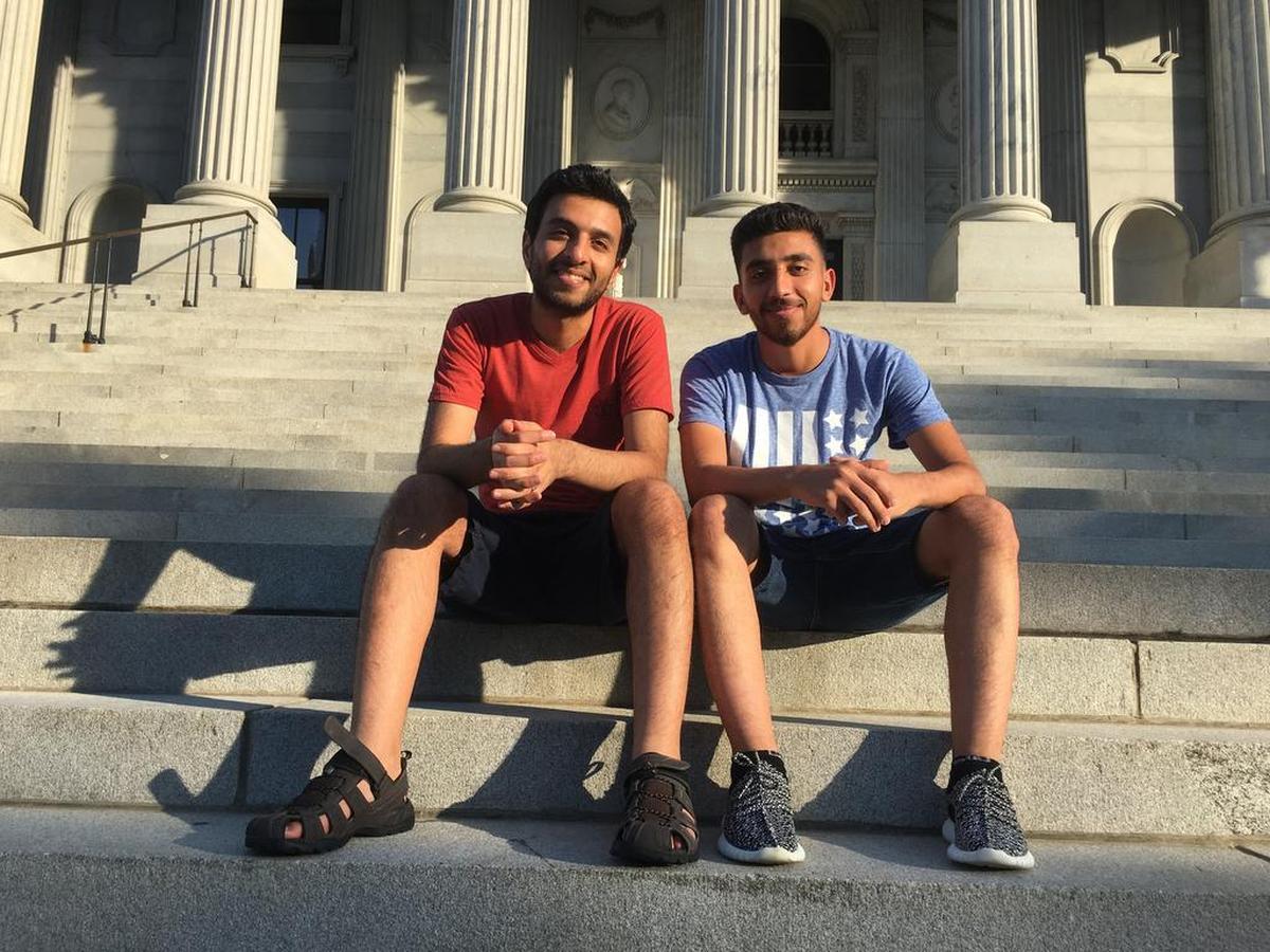 Brothers Zaid and Hasan Alibadi sit on the steps of the SC State House. Hasan was admitted to the U.S. as a refugee because of Zaid’s work with the U.S. military in Iraq. Their sister Shahad is still trying to get out of the country.