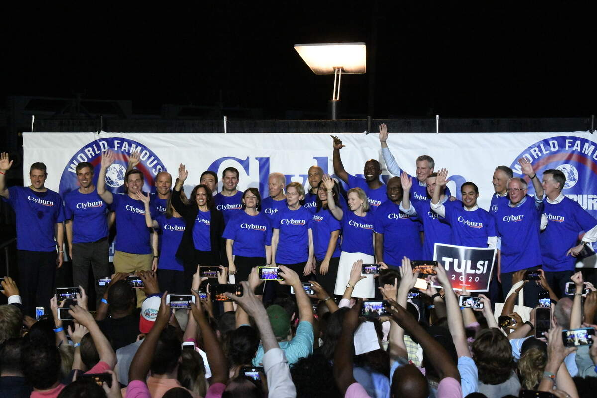 Twenty-one of the Democrats seeking the party’s presidential nomination pose together after House Majority Whip Jim Clyburn’s “World Famous Fish Fry,” Friday, June 21, 2019, in Columbia, S.C. (AP Photo/Meg Kinnard)