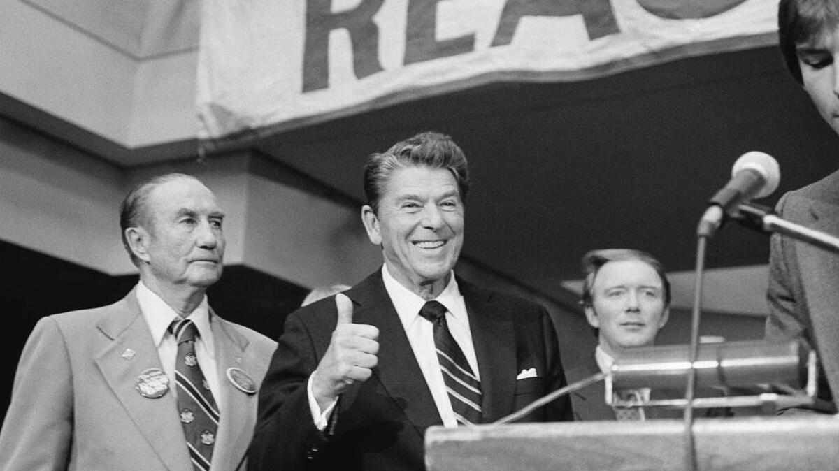 Then-GOP presidential candidate Ronald Reagan gives a thumbs up sign as he stands with Sen. Strom Thurmond, R-S.C., left, after delivering a campaign speech in Greenville in October 1980.