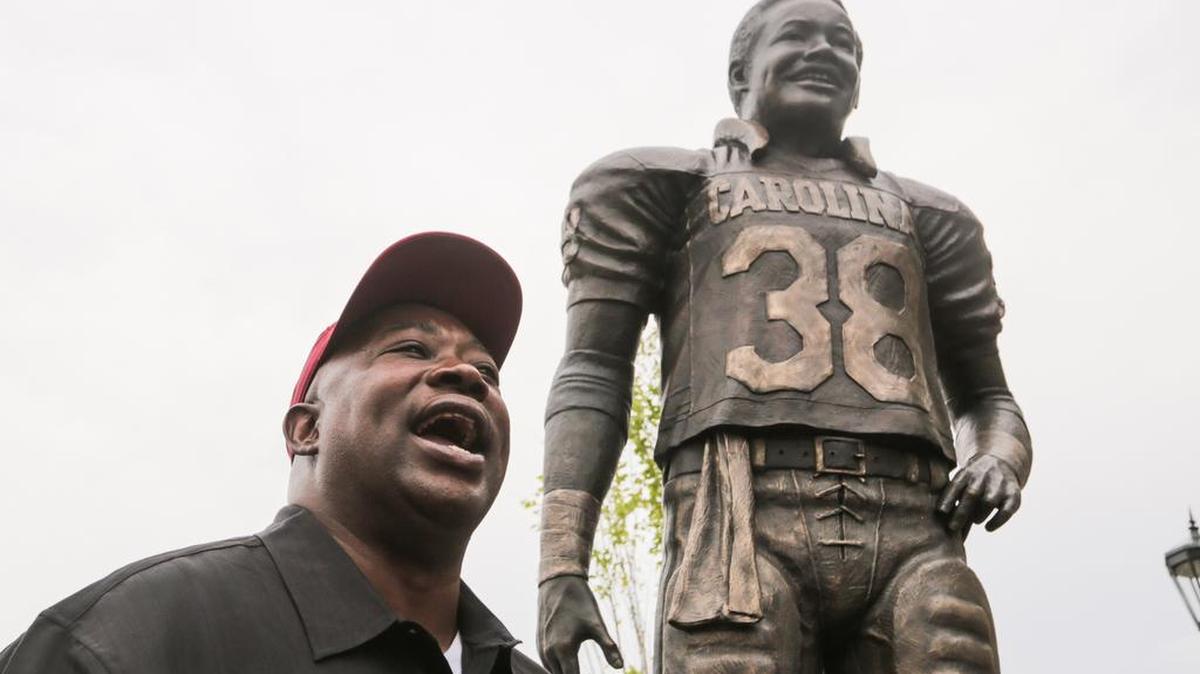 George Rogers poses with his statue that was unveiled during a ceremony before the South Carolina-Kentucky game in September.