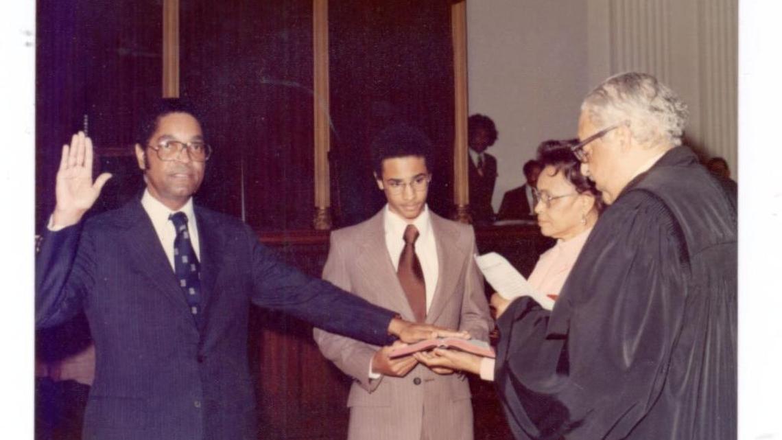 In 1976, Matthew Perry became the Deep South’s first black lawyer appointed to the federal bench. Here, in a photo from the family photo album, Perry is sworn in by Supreme Court Justice Thurgood Marshall, the first black on the U.S. Supreme Court and Perry’s mentor. Son Michael and wife Hallie hold the Bible.