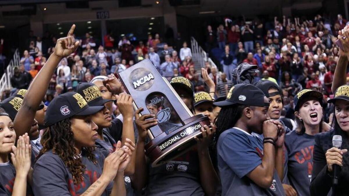 South Carolina players, including Olivia Gaines and Tina Roy celebrate after USC defeated Florida State to clinch the Division 1 Regional Tournament. Coach Dawn Staley is at right.