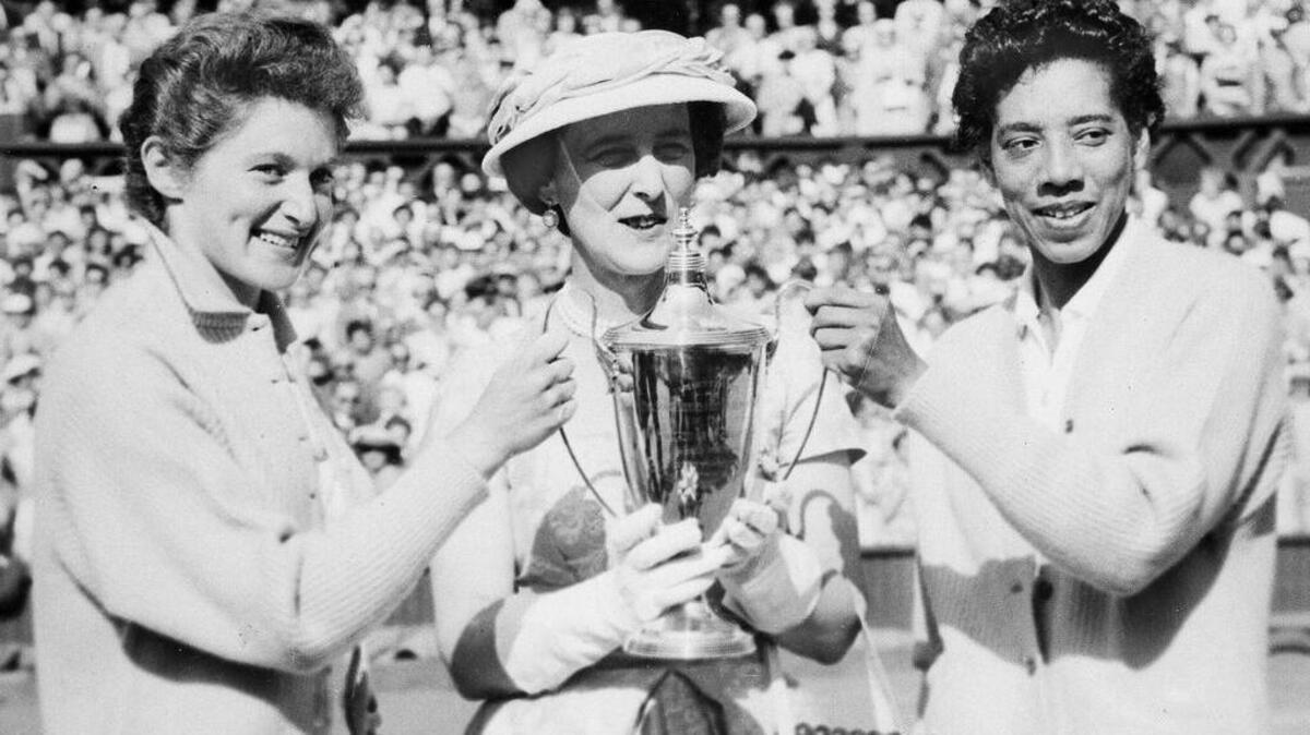 The Duchess of Kent, center, presents the trophy for the Ladies’ Doubles title to Angela Buxton, left, and Althea Gibson, right, following their victory at Wimbledon, England, July 7, 1956. They defeated the Australian team of Fay Muller and Daphne Seeney, 6-1, 8-6.