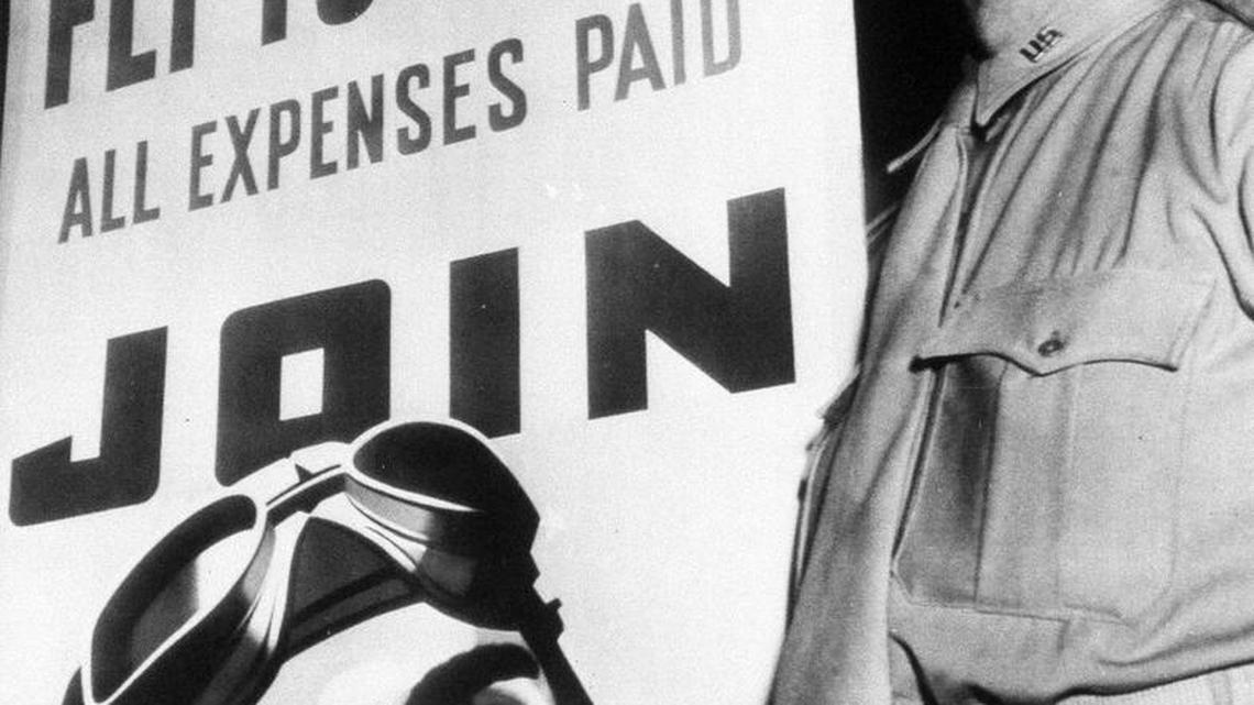 Brigadier General James Doolittle is seen standing by the new Air Force poster in Washington, May 19, 1942.