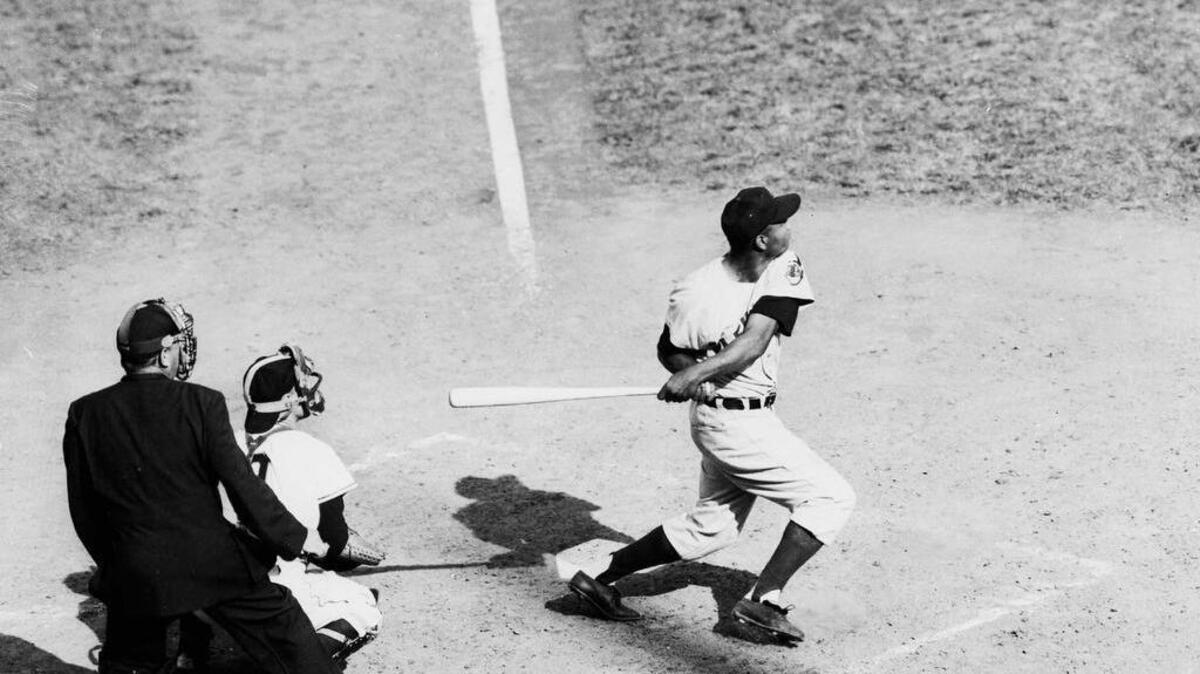 Cleveland Indians Larry Doby hits a single at the Polo Grounds in New York in this Sept. 1954 file photo. In 1947, the year that changed baseball forever, Doby broke the color barrier in the American League when he pinch-hit for the Indians against the Chicago white Sox at Comiskey Park. It was 11 weeks after Robinson played his first game for the Brooklyn Dodgers. Doby was brushed back, heckled and spit on just like Robinson, yet he never attained the same status as sports pioneer and civil rights hero.