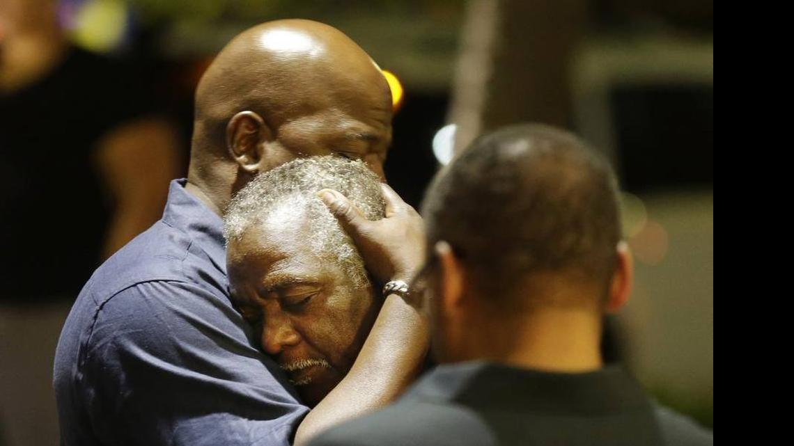 
Worshippers embrace following a group prayer Wednesday night across the street from the scene of a shooting at Emanuel AME Church in Charleston. 
