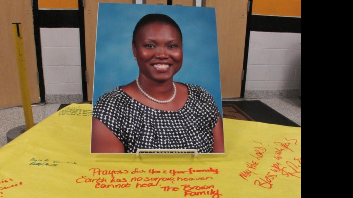 
A picture of Sharonda Coleman-Singleton sits on a large paper signed by students, teachers and friends on Thursday, June 18, 2015, in Goose Creek, S.C. Goose Creek High School held a memorial for the speech pathologist and girls track coach, who was one of the nine people killed on Wednesday night by a gunman at Emanuel AME Church where she was a part-time minister.
