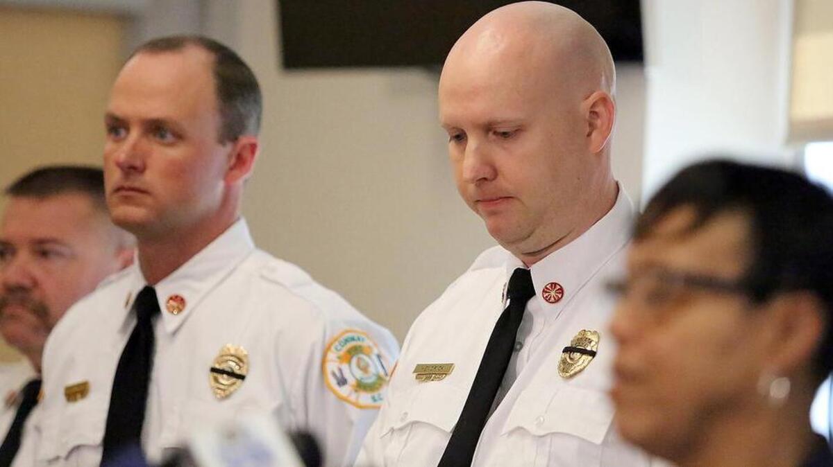 Conway Fire Chief Phillip L. Hendrick Jr. (second from right) listens as Conway Mayor Barbara Blain-Bellamy speaks about the city's loss of firefighter Chris Ray on Monday, March 21, 2016. Ray died on duty Sunday afternoon while responding to a fire within a half a mile from the fire house. He was struck and killed by a fire engine on Tinkertown Avenue, a street over from the burning home on Hickory Circle. The hydrant is on Tinkertown Avenue. Horry County coroner's office said preliminary autopsy results show multiple traumatic injuries. Ray had been a Conway firefighter since 2010. He leaves behind a wife and two daughters. Funeral arrangements have not been announced as of Monday afternoon.