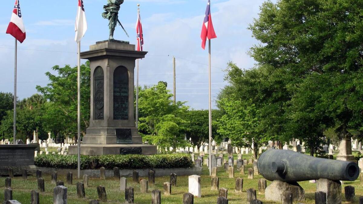 Confederate flags fly over the graves of Confederate soldiers at Magnolia Cemetery in Charleston on Tuesday.