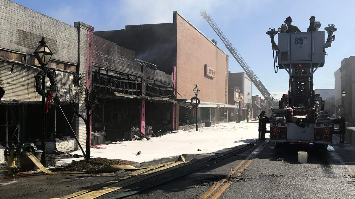 Authorities work the scene of a arson-caused fire that gutted three buildings in downtown Holly Hill in January.