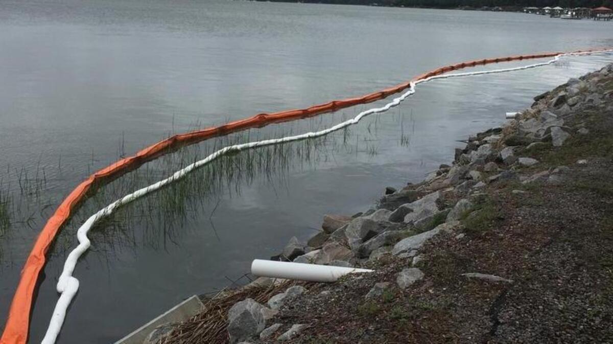 Booms were in place Sunday to contain oil found in the water behind Beaufort Memorial Hospital. The leak is believed related to the leak of hundreds of gallons of heating fuel oil into the hospital’s boiler room May 23.