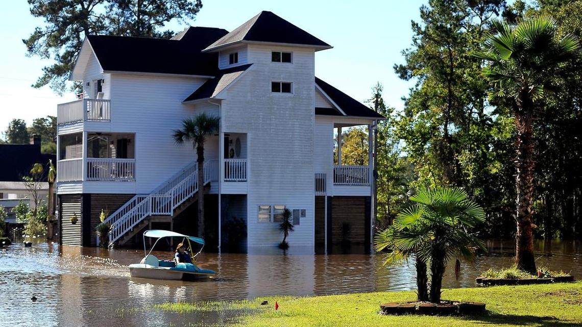 
Denise Bass uses a paddle boat to travel from her beach home to dry land on Wednesday, Oct. 7, 2015. Bass lives off Forestbrook Road in Socastee, S.C. She and her husband have been stuck at the home since Oct. 2, only leaving to go to the grocery store. 
