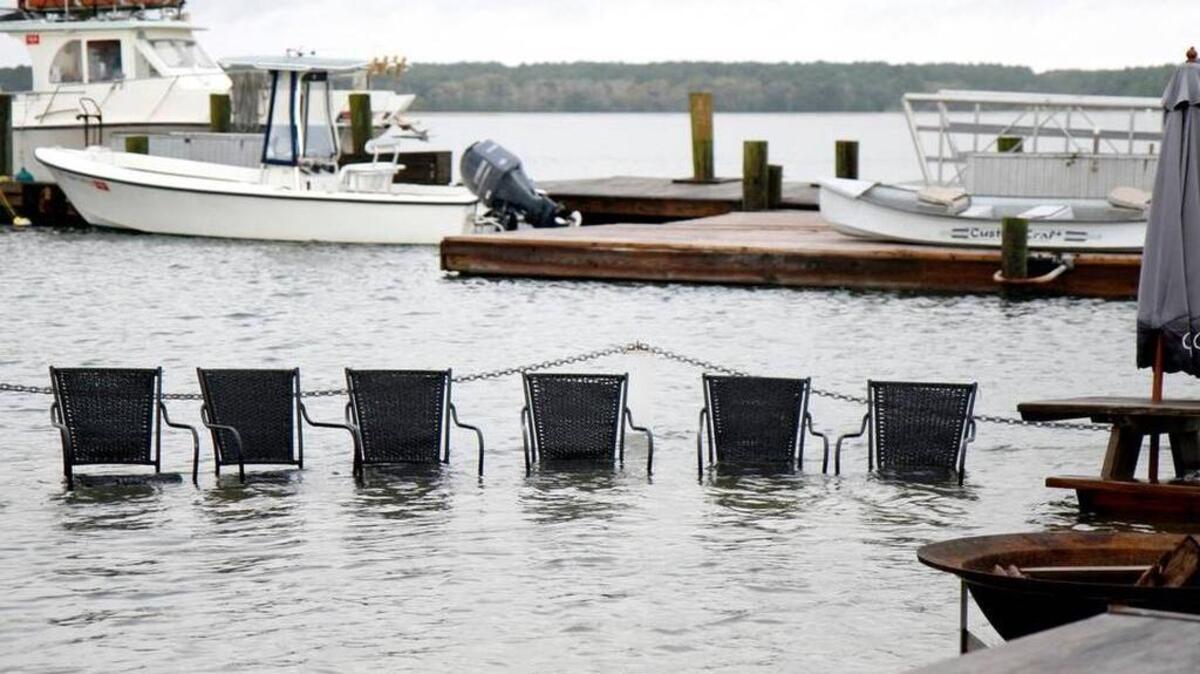 Chairs sit submerged on the outside patio at Hudson's Seafood on Hilton Head Island after a king tide the morning of Oct. 28. Andrew Carmines, the restaurant's owner, says the day's high tides were not nearly as bad as the previous morning, where the water came into the room but receded in time for lunch.