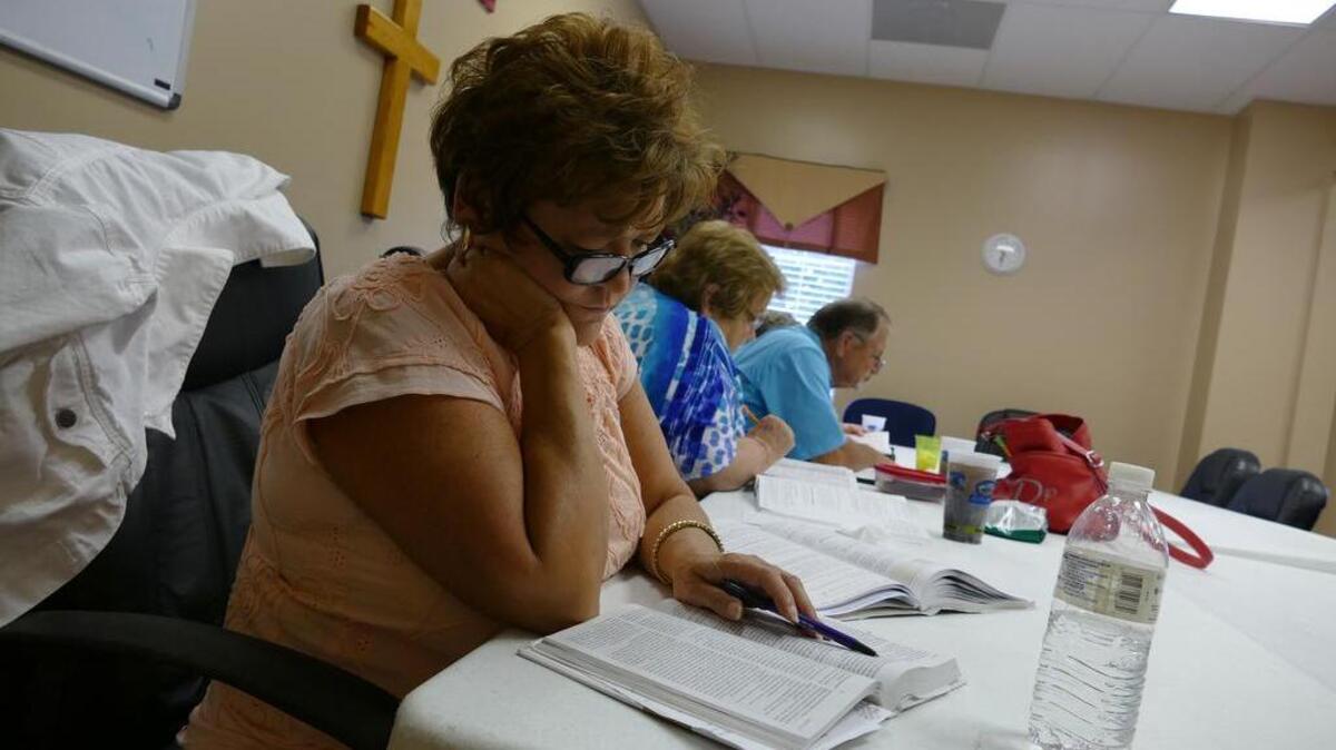 
Karen Cook reads along during a Bible study at Park Ridge Baptist Church on Wednesday. Park Ridge assembled a safety team two years ago to respond to different emergencies during church events.
